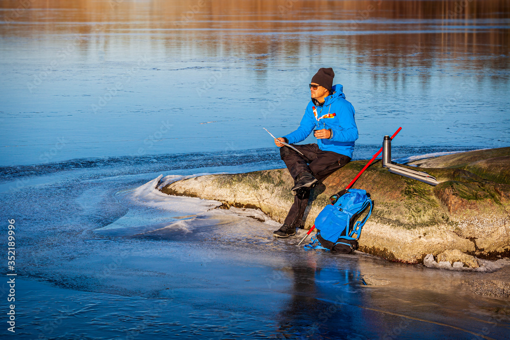 Fotografie Man sitting and resting on rock