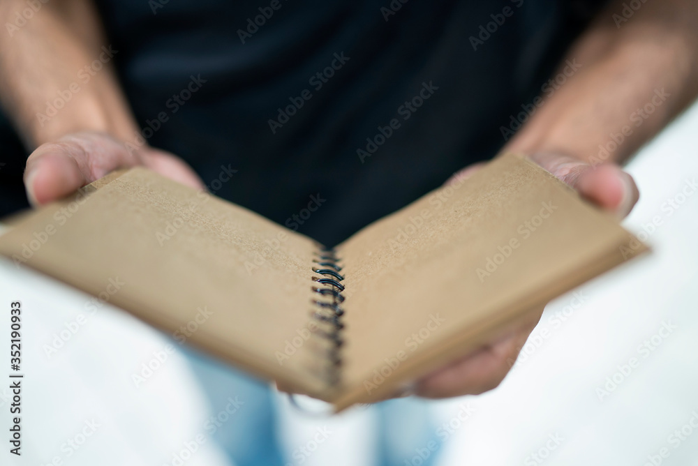 blank notebook held in hand

