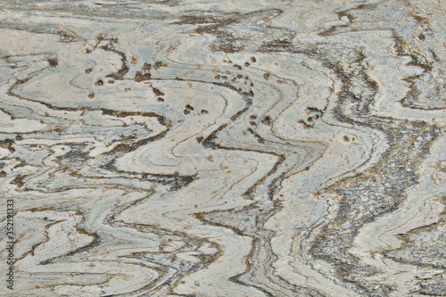 White rock background with dark lines The texture stone with a wavy pattern.