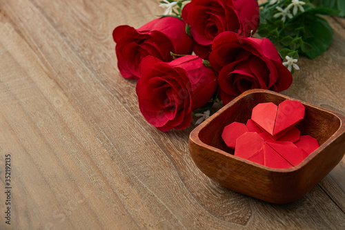Valentines day red heart rose on wooder table background, top view with copy space