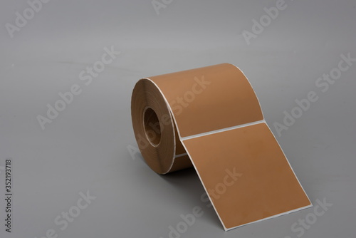 A roll of thermal paper against a gray background photo