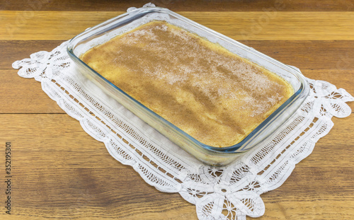 Milktart in glass dish on oak table photo