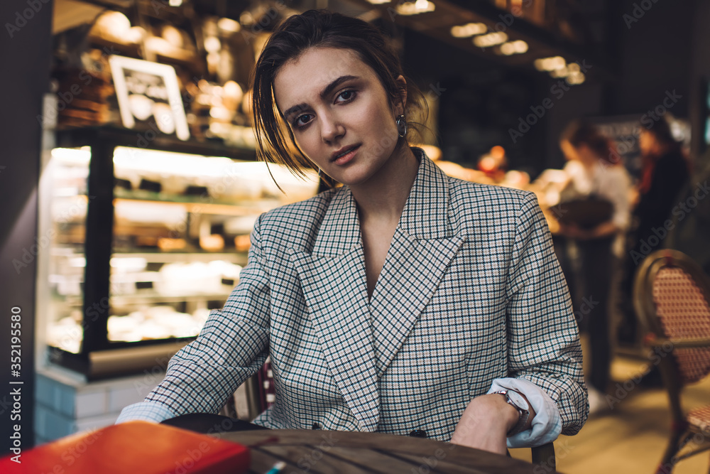 Confident trendy woman sitting in restaurant Confident trendy woman sitting in restaurant