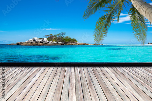 Fototapeta Naklejka Na Ścianę i Meble -  Wooden floor or plank on sand beach. For product display.Calm Sea and Blue Sky Background.tropical in summer.