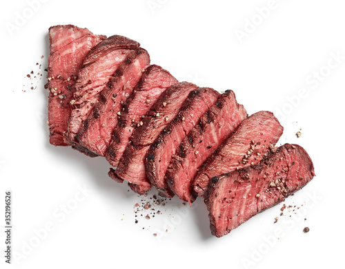 Grilled sliced beef tenderloin steak with pepper isolated on white background top view
