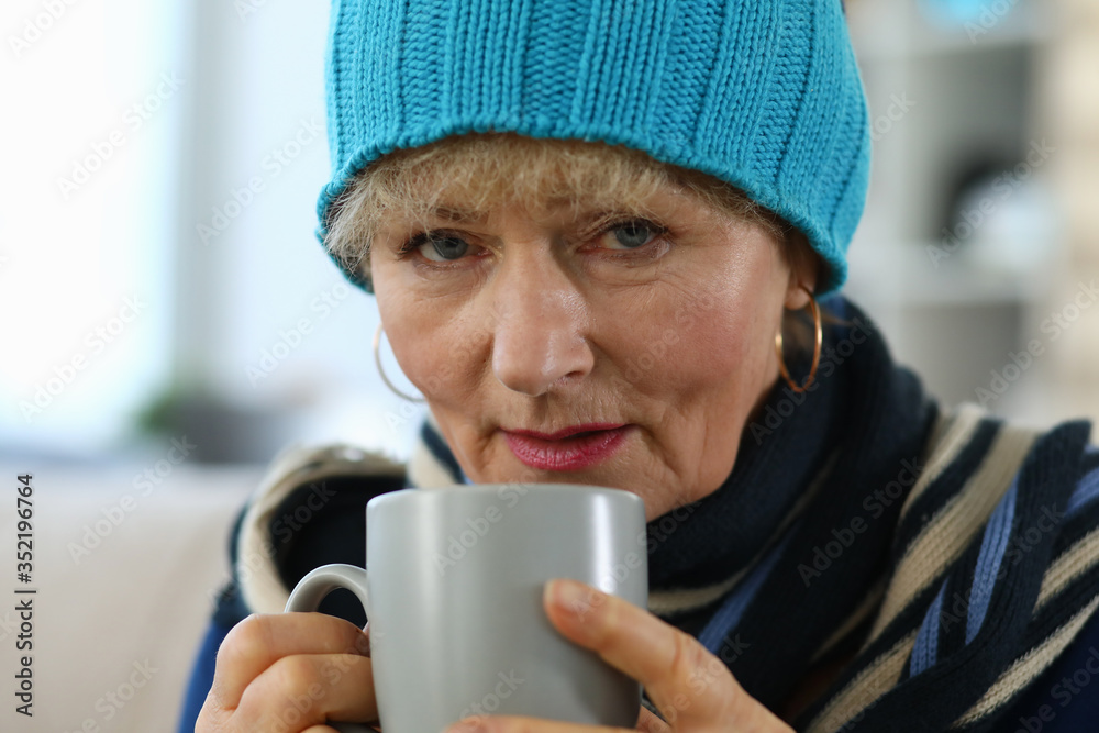 Elderly woman feels sick and drinks tea at home Elderly woman feels sick and drinks tea at home