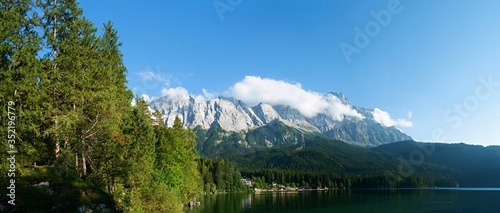 View of Zugspitze Mountains seen from bank of Lake Eibsee