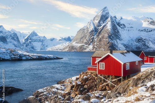 Wallpaper Mural Famous tourist attraction Hamnoy fishing village on Lofoten Islands, Norway with red rorbu houses in winter