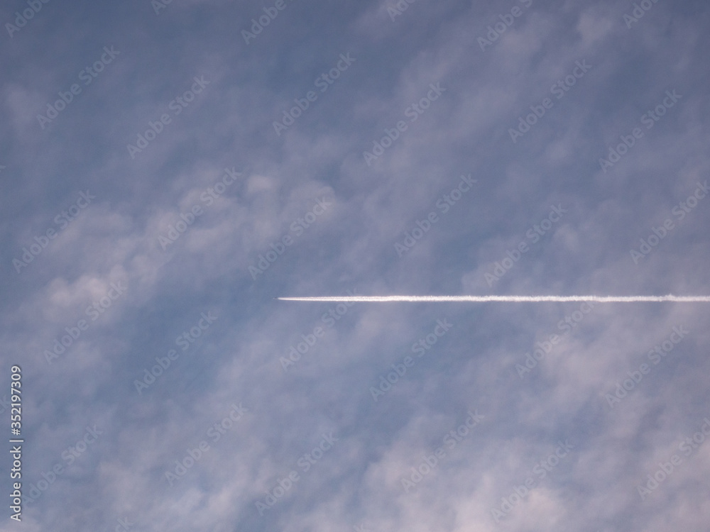 Trace of an airplane against blue sky Trace of an airplane against blue sky