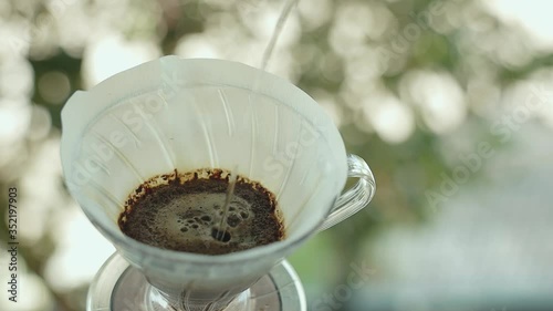 Coffee Drip Concept. Pouring Hot Water from Kettle into a Dripper. Making Hot Coffee Drink in Nature. Zen and Cozy Living. Top View