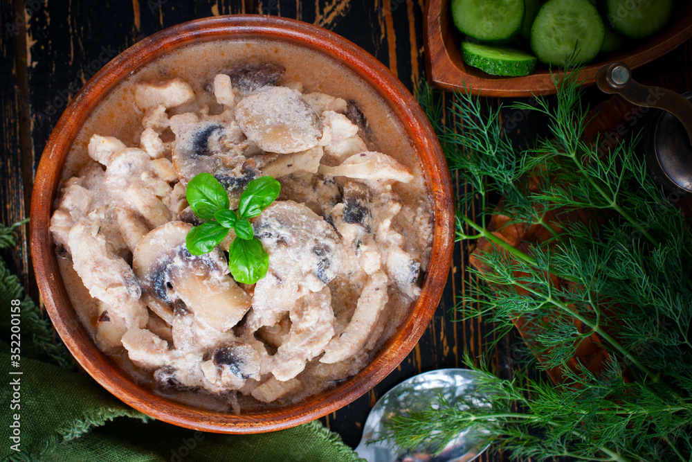 Stroganoff with chicken and mushrooms in a wooden bowl, selective focus Stroganoff with chicken and mushrooms in a wooden bowl, selective focus