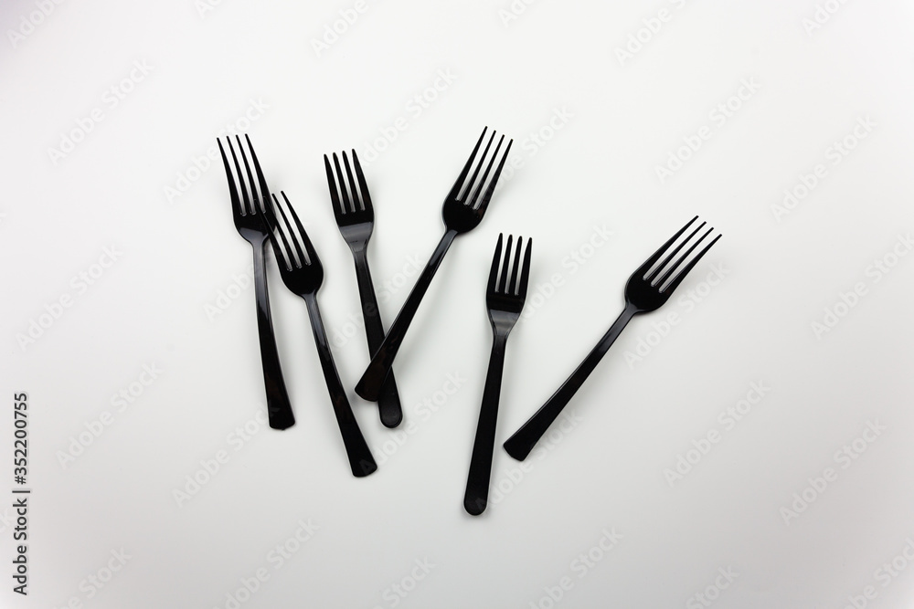 Plastic items. Black appliances for food. For the presentation of waste recycling. Disposable tableware Plastic items. Black appliances for food. For the presentation of waste recycling. Disposable tableware