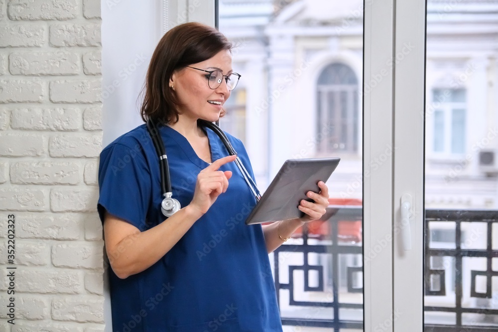 Female doctor talking online with patient using digital tablet, video call Female doctor talking online with patient using digital tablet, video call