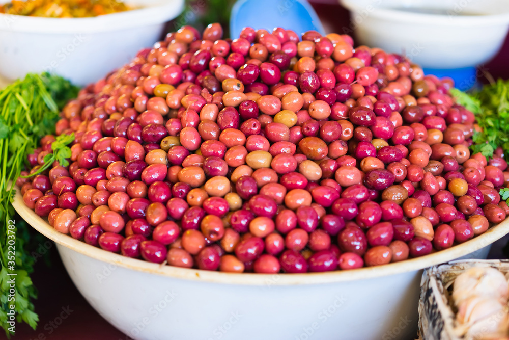 A lot of shiny marinated olives in the Marrakesh market. Selective focus. A lot of shiny marinated olives in the Marrakesh market. Selective focus.
