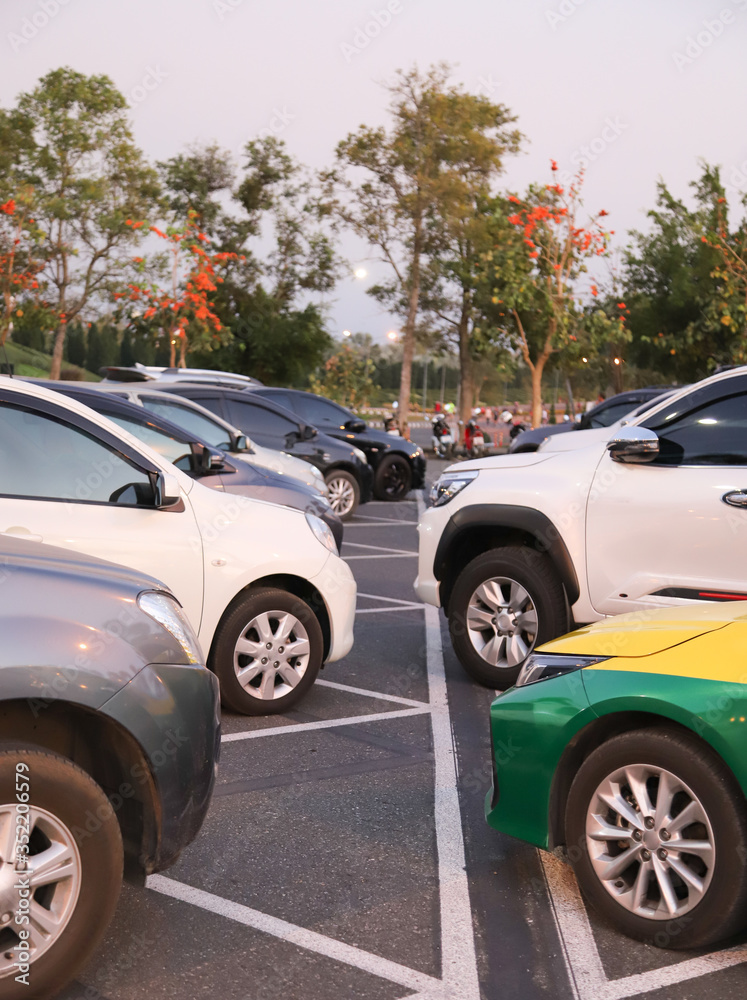 Image of cars parking in the opposite side in outdoor parking with natural background. Vertical view. Image of cars parking in the opposite side in outdoor parking with natural background. Vertical view.