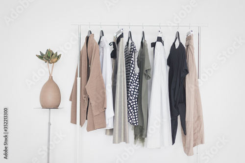 Obraz na plátně A rack with stylish clothes next to a white wall in the room