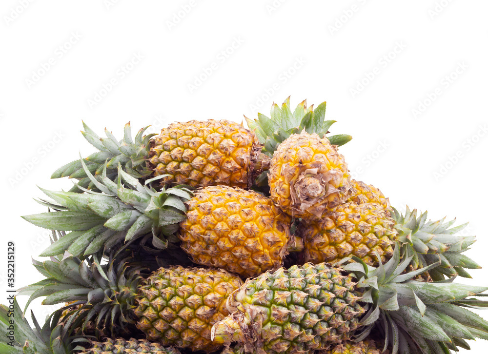 Pineapple fruits heap isolated on white background Pineapple fruits heap isolated on white background