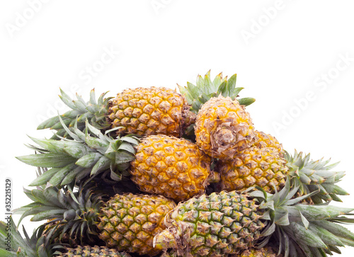 Pineapple fruits heap isolated on white background