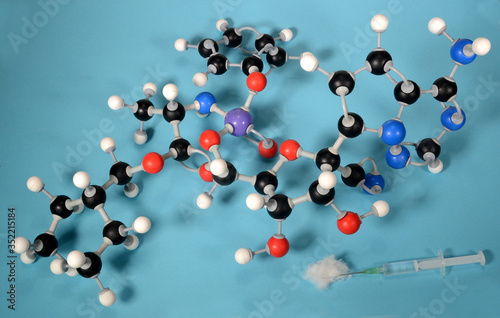 Molecule model of the antiviral preparate remdesivir that may be able to calm the symptoms of Covid 19 virus. White is Hydrogen, black is Carbon, blue is Nitrgen, red is Oxygen, Lilac is Phosphor. photo