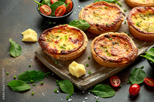 Cheddar cheese and spring onion omelette tarts served on wooden board with side salad. Healthy breakfast food