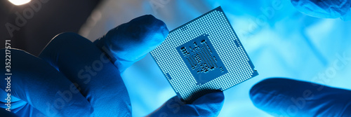 Hands in gloves hold chip testing microelectronics photo