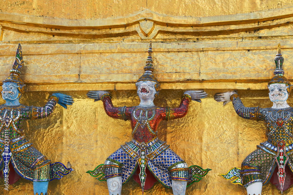 colorful tradition demon statue which support golden pagoda