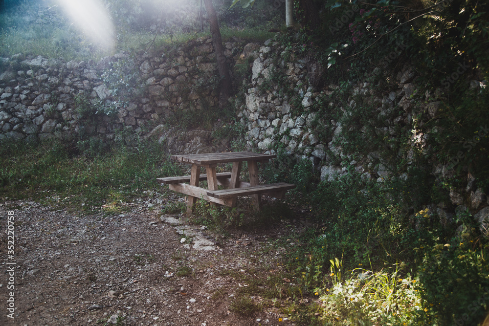 A wooden picnic table in the woods in Italy Positano Amalfi Coast A wooden picnic table in the woods in Italy Positano Amalfi Coast