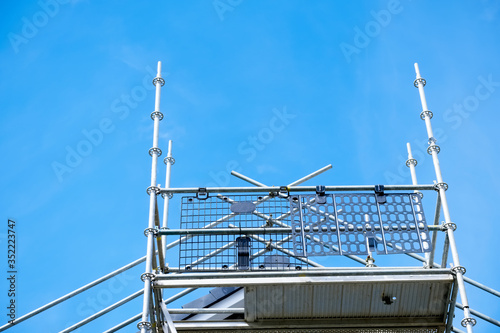Scaffold platform and poles close up in blue sky at construction building site