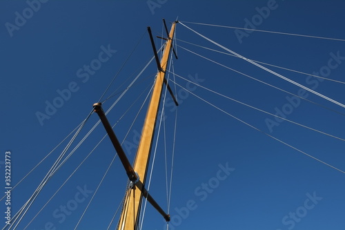 An isolated mast of a sailing boat.