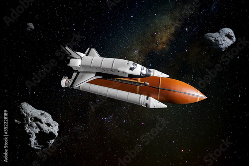 Fototapeta Naklejka Na Ścianę i Meble -  Space shuttle orbiting in  a space and starry background. Elements of this image furnished by NASA.