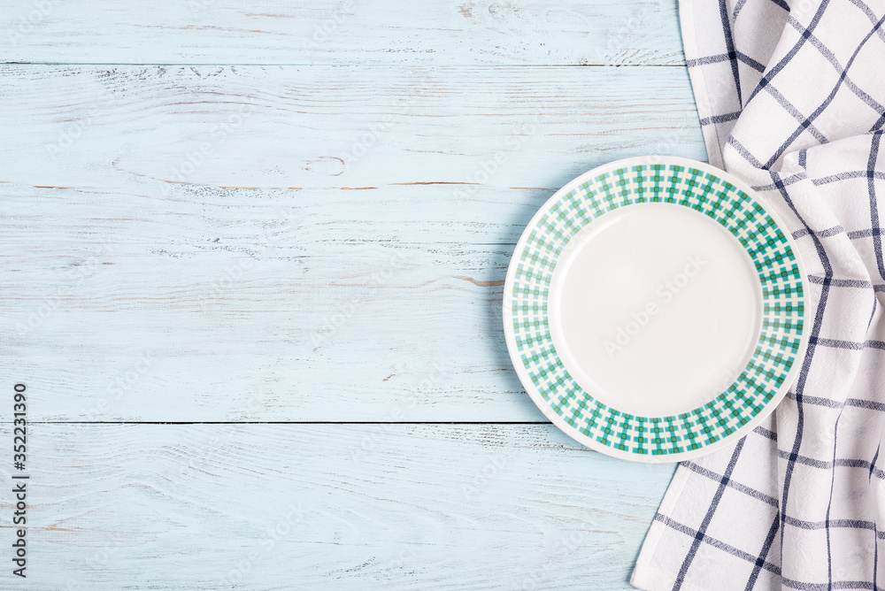 white plate with a pattern on a blue wooden background