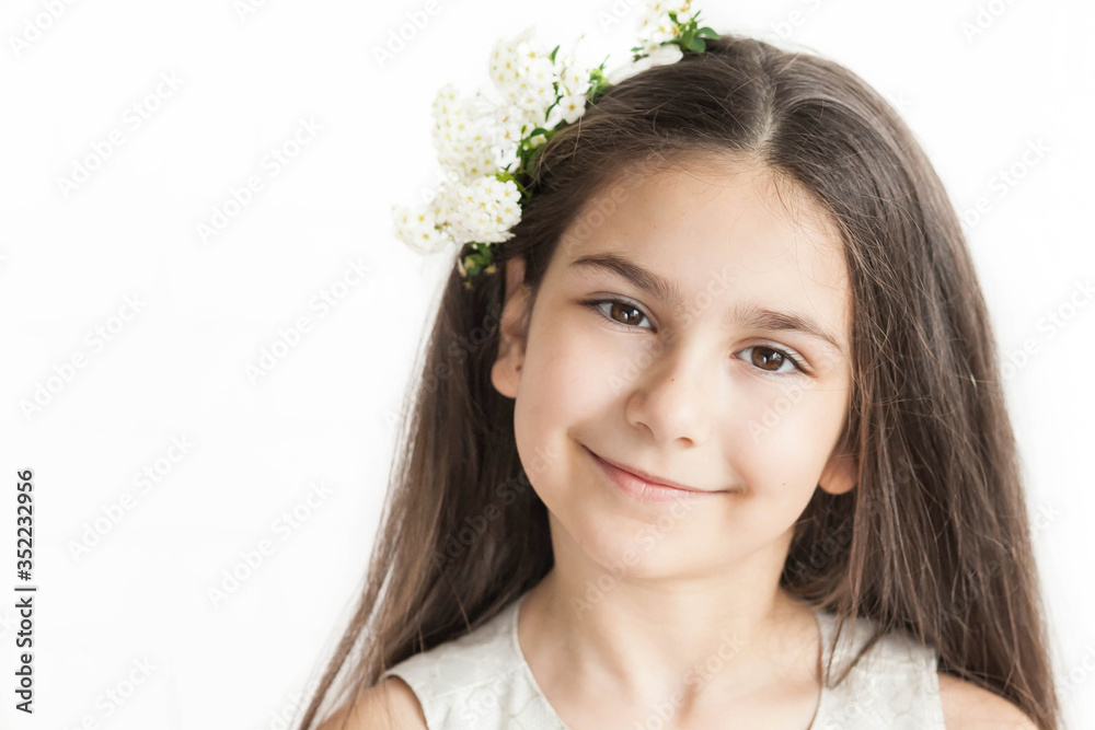 Beautiful teenager girl with white flowers in long dark hair