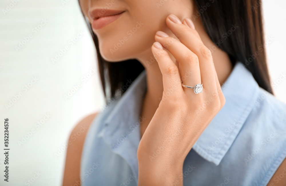 Young woman wearing beautiful engagement ring, closeup Young woman wearing beautiful engagement ring, closeup