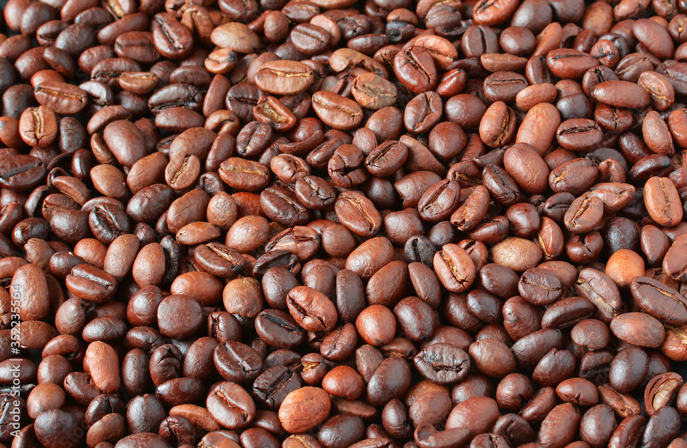 Fragrant, roasted coffee beans, top view, background from coffee beans Fragrant, roasted coffee beans, top view, background from coffee beans