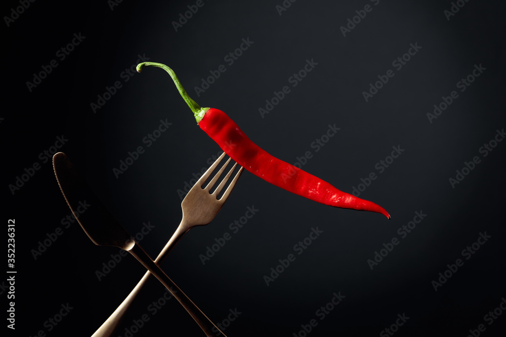 Hot chili red pepper on a fork. Spice concept. Hot chili red pepper on a fork. Spice concept.