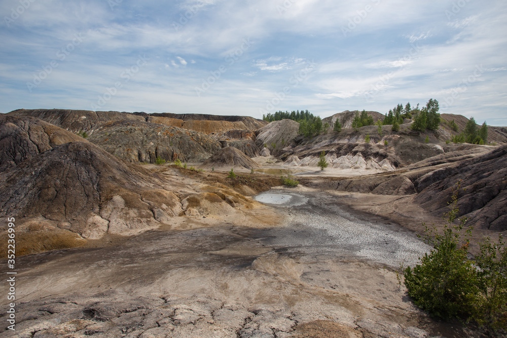 Amazing kaolin clay marsian landscape quarry open pit at summer day