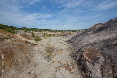 Amazing kaolin clay marsian landscape quarry open pit at summer day