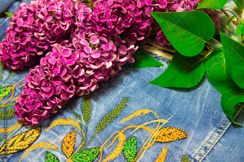 a branch of lilac on a denim jacket