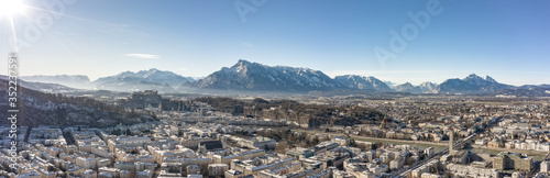 Panoramic aerial drone view of Salzburg snowy north town with view of Unesberg mountain in winter morning