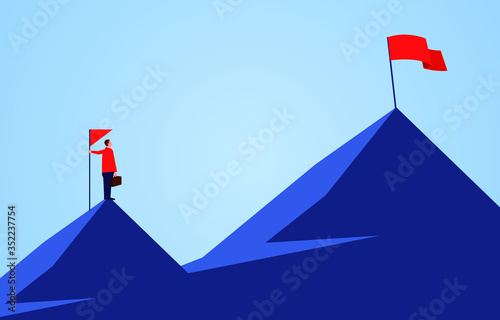Businessman holding a flag standing on the top of the mountain, looking to another higher mountain, business goals and challenges