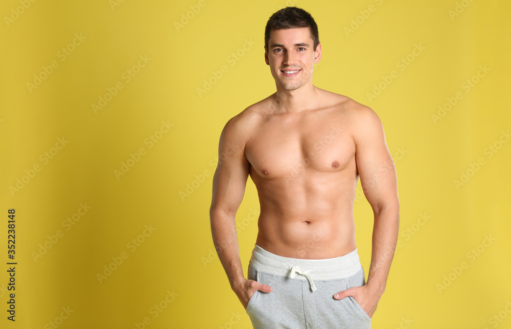 Man with sexy body on yellow background. Space for text