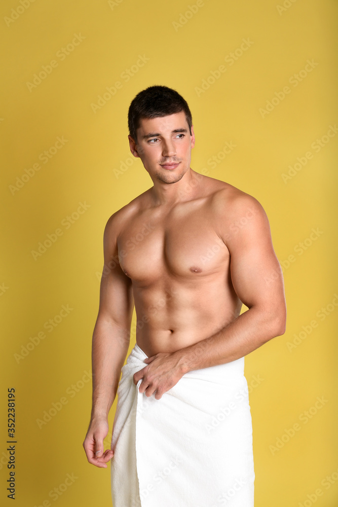 Fototapeta premium Man with sexy body on yellow background