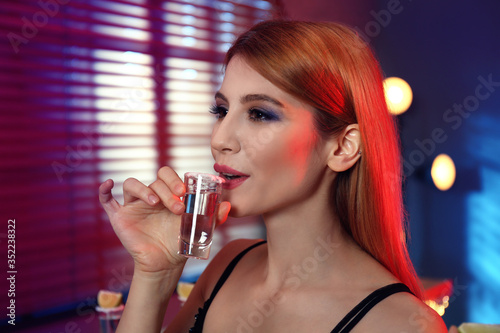 Photography Young woman with Mexican Tequila shot in bar