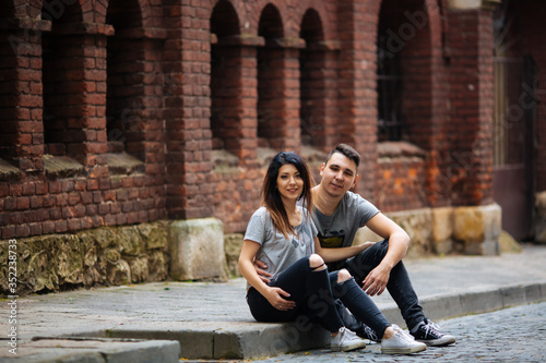 couple posing on the streets of a European city in summer weather. © ostap_davydiak