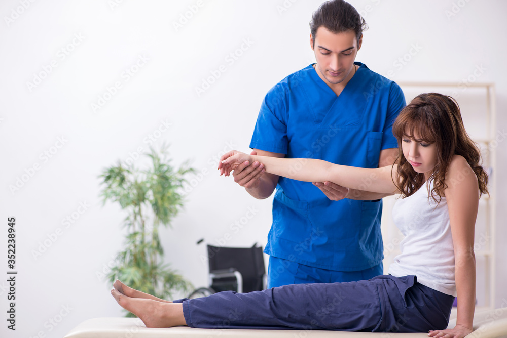 Injured woman visiting young male doctor osteopath Injured woman visiting young male doctor osteopath