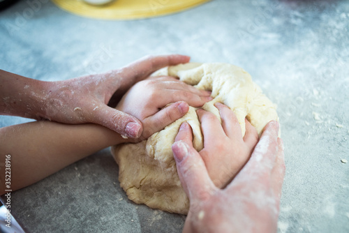 Mom and baby make dough from flour