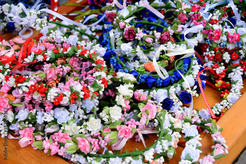 colorful wreaths of artificial flowers