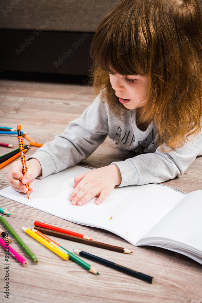 Little girl drawing with pecils. Selective focus. Shallow depth of field. Little girl drawing with pecils. Selective focus. Shallow depth of field.