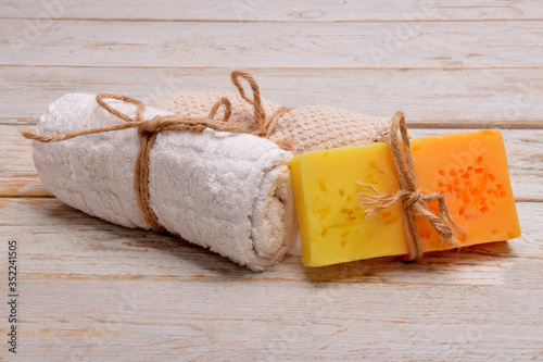 hand-peeling soap handmade with fruit fragrances next to towels