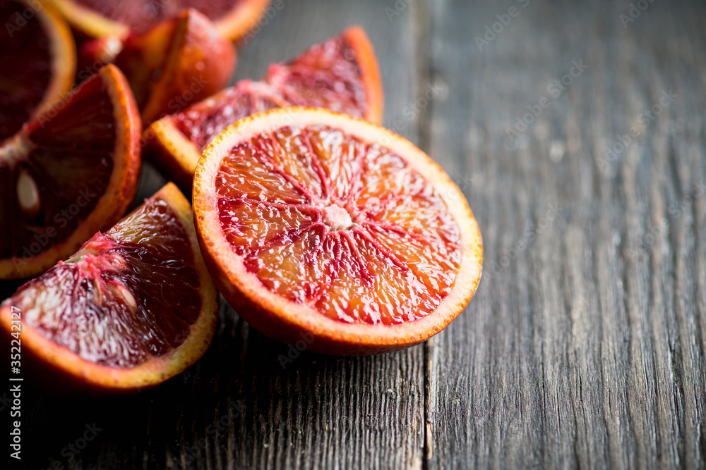 Ripe bloody oranges on the rustic background. Selective focus. Shallow depth of field. Ripe bloody oranges on the rustic background. Selective focus. Shallow depth of field.